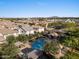 Aerial view of community pool, cabanas and lounge chairs with desert mountain views at 2868 E Binner Dr, Chandler, AZ 85225