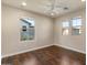 Bright bedroom featuring hardwood floors, a ceiling fan, and large windows offering ample natural light at 2868 E Binner Dr, Chandler, AZ 85225