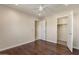 Bedroom featuring wood floors, a ceiling fan, and an open closet and entry to adjoining room at 2868 E Binner Dr, Chandler, AZ 85225