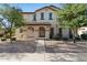 Charming two-story home with a tiled roof and landscaped yard with mature trees and covered front porch at 2868 E Binner Dr, Chandler, AZ 85225