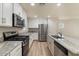 Modern kitchen featuring stainless steel appliances, granite countertops, and white cabinets at 2868 E Binner Dr, Chandler, AZ 85225