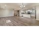 Open-concept living room with adjacent kitchen and staircase, featuring hard wood floors at 2868 E Binner Dr, Chandler, AZ 85225