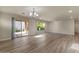 Open living room with chandelier, wood floors, large windows and sliding glass door at 2868 E Binner Dr, Chandler, AZ 85225