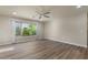 Bright living room with wood-look floors, large windows, and a ceiling fan at 2868 E Binner Dr, Chandler, AZ 85225