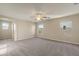 A living room featuring a carpeted floor, a ceiling fan, and three windows at 2868 E Binner Dr, Chandler, AZ 85225
