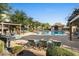 Community pool area featuring a bath house, ample seating, and well-maintained landscaping at 2868 E Binner Dr, Chandler, AZ 85225