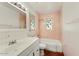Bathroom with stained glass window, tub and shower combo, and sink at 3532 N Carhill Ave, Scottsdale, AZ 85251