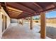 Back patio with brick columns, exposed beams, and gravel yard at 3532 N Carhill Ave, Scottsdale, AZ 85251