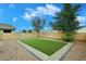 Picture perfect backyard featuring faux grass, pavers, rock and block wall at 36950 W Mondragone Ln, Maricopa, AZ 85138