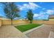 Well-maintained backyard with faux lawn, pavers and decorative gravel at 36950 W Mondragone Ln, Maricopa, AZ 85138