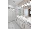 Bathroom featuring dual sinks, marble countertops, glass shower, and modern lighting at 36950 W Mondragone Ln, Maricopa, AZ 85138