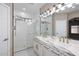 Bathroom with marble vanity, dual sinks, modern fixtures and a glass-enclosed shower at 36950 W Mondragone Ln, Maricopa, AZ 85138