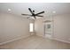 Spacious bedroom with wood flooring, a ceiling fan, and an ensuite bathroom with sliding door entrance at 36950 W Mondragone Ln, Maricopa, AZ 85138