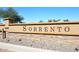 Landscaped Sorrento community sign with brick accent and blue sky background at 36950 W Mondragone Ln, Maricopa, AZ 85138