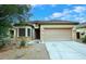Charming single-story home featuring a tile roof, stone accents, and a well-maintained front yard at 36950 W Mondragone Ln, Maricopa, AZ 85138