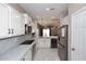 Bright and airy kitchen featuring white cabinets, marble countertops, and modern stainless-steel appliances at 36950 W Mondragone Ln, Maricopa, AZ 85138