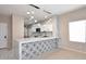 Modern kitchen with white cabinets, marble countertops, stainless steel appliances, and decorative lighting at 36950 W Mondragone Ln, Maricopa, AZ 85138