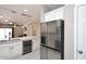 Modern kitchen featuring stainless steel refrigerator, wine cooler, and marble countertops at 36950 W Mondragone Ln, Maricopa, AZ 85138