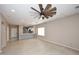 Bright, open-concept living room features hardwood floors and modern fixtures, ideal for entertaining at 36950 W Mondragone Ln, Maricopa, AZ 85138