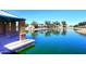 A scenic pond features a tranquil lake, beautiful stonework, and well-kept landscaping at 36950 W Mondragone Ln, Maricopa, AZ 85138