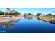Scenic pond surrounded by lush landscaping offers a tranquil view, with an ornate gazebo on the water's edge at 36950 W Mondragone Ln, Maricopa, AZ 85138