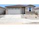 Charming single-story home features a two-car garage and neutral-toned exterior with rock landscaping at 37125 W Prado St, Maricopa, AZ 85138