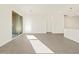 Bright open-concept living room with tiled floors, recessed lights, and sliding glass door to the patio at 37125 W Prado St, Maricopa, AZ 85138