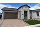 Inviting single-Gathering home with stone accents, a spacious garage, and a well-paved driveway, designed for comfort at 3738 E Rochelle Cir, Mesa, AZ 85213