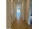 Bright hallway with smooth flooring and white walls leading to a well-lit living space with access to the backyard at 3738 E Rochelle Cir, Mesa, AZ 85213