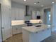 Modern kitchen with white cabinets, stainless steel appliances, and a large island, perfect for cooking and entertaining at 3738 E Rochelle Cir, Mesa, AZ 85213
