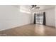 A bright bedroom featuring wood-look floors and sliding glass doors at 3828 W Townley Ave, Phoenix, AZ 85051