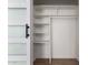 A well-organized closet with shelves, a hanging rod, and a sliding door, offers ample storage space at 3828 W Townley Ave, Phoenix, AZ 85051