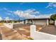 Exterior shot of a single-story home with a spacious driveway and modern architectural features at 3828 W Townley Ave, Phoenix, AZ 85051