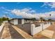 Expansive exterior of a single-story home with a long driveway and modern front yard design at 3828 W Townley Ave, Phoenix, AZ 85051