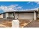 Exterior shot of a single-story home with a large garage and modern architectural details at 3828 W Townley Ave, Phoenix, AZ 85051