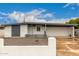Exterior view of a single-story home featuring a two-car garage and modern architectural elements at 3828 W Townley Ave, Phoenix, AZ 85051