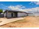 Back exterior view of home with covered area, gated access and concrete patio at 3828 W Townley Ave, Phoenix, AZ 85051