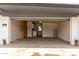 A spacious garage with ample storage space, a workbench, and an open door for easy access at 3828 W Townley Ave, Phoenix, AZ 85051
