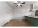 Open-concept living space featuring wood flooring, seamless access to the kitchen, and modern lighting at 3828 W Townley Ave, Phoenix, AZ 85051