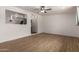 Inviting living room featuring wood floors, an open layout, and a seamless transition to the kitchen at 3828 W Townley Ave, Phoenix, AZ 85051