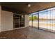 The covered patio features a secure iron gate and views of the backyard, providing a perfect outdoor retreat at 3828 W Townley Ave, Phoenix, AZ 85051