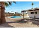 Lush backyard with a sparkling pool, mature palms, and patio area at 407 E Orion St, Tempe, AZ 85283