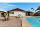 The backyard features a sparkling pool with a slide and palm trees at 407 E Orion St, Tempe, AZ 85283