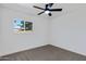Cozy bedroom featuring a ceiling fan and a window with a view at 407 E Orion St, Tempe, AZ 85283