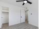 Bedroom with gray wood flooring, open closet and ceiling fan at 407 E Orion St, Tempe, AZ 85283