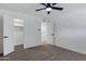 Bedroom featuring a ceiling fan, closets, and neutral carpet at 407 E Orion St, Tempe, AZ 85283