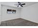 Bedroom with a ceiling fan, a large window, and neutral carpet at 407 E Orion St, Tempe, AZ 85283