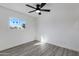Bright bedroom with modern ceiling fan and large sunlit window at 407 E Orion St, Tempe, AZ 85283