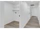 Bright laundry room with gray wood flooring, white walls and shelves at 407 E Orion St, Tempe, AZ 85283