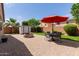 Spacious backyard featuring a paved patio, fire pit, storage shed, manicured lawn, and mature landscaping at 41342 W Elm Dr, Maricopa, AZ 85138